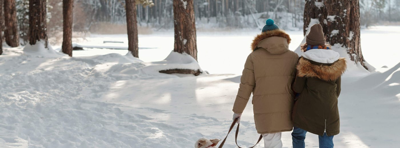 Couple going out with the dog in the woods